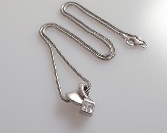 Danish Scrouples silver and zirconia tapering curve pendant, together with a silver chain necklace