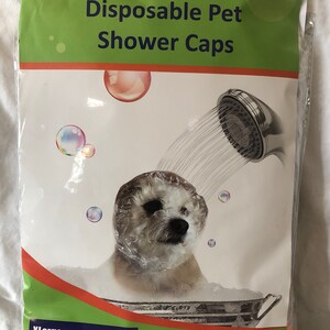 May include: A package of 12 disposable pet shower caps for dogs with large ears. The package is labeled "CozyEars Disposable Pet Shower Caps" and "XLarge 14"x12"x3.5"x3.5". The package also states "For dogs with very big ears or dogs over 75 lbs". The package shows a white dog wearing a shower cap in a tub of water.