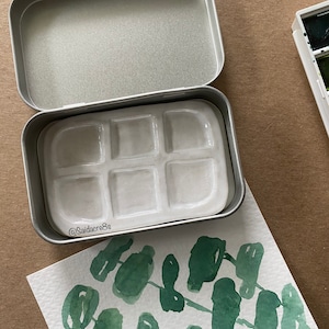 Ceramic 6 well watercolor palette in the tin.