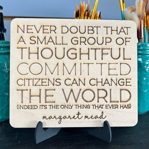 May include: A wooden sign with the quote "Never doubt that a small group of thoughtful committed citizens can change the world. (Indeed it's the only thing that ever has) - Margaret Mead"