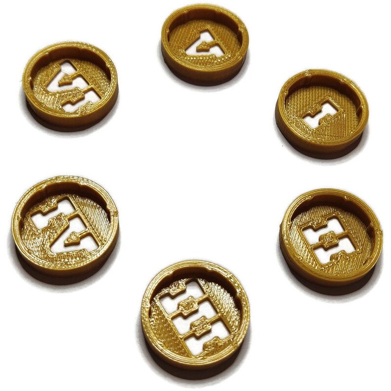 May include: Six gold-colored plastic tokens with the number "4" printed on them. The tokens are arranged in a circle on a white background.