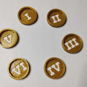 May include: Six gold-colored round tokens with Roman numerals I through VI printed in white.