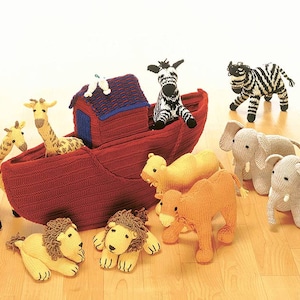 May include: A red knitted ark with a blue roof, filled with a zebra, two giraffes, and a camel.  There are two lions, two elephants, and a dove on the floor.