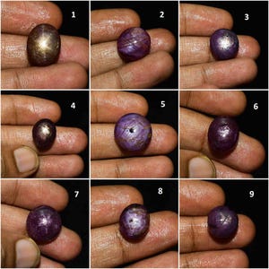 May include: A collection of nine individual cabochon-cut star rubies and star sapphires, each displaying a distinct asterism effect. The gemstones vary in shades of deep purple, reddish-purple, and brownish-grey, featuring a smooth, polished surface.