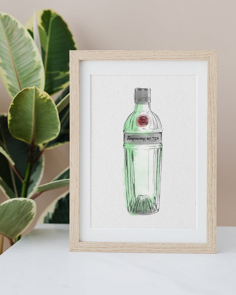 May include: A framed watercolor illustration of a green glass bottle of Tanqueray No. Ten gin. The bottle is depicted in a simple, minimalist style with a white background.