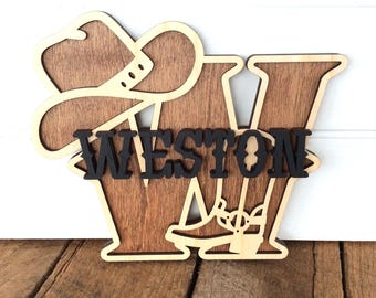 May include: Wooden cutout of the letter W with a cowboy hat and boot design. The name Weston is spelled out in black letters.