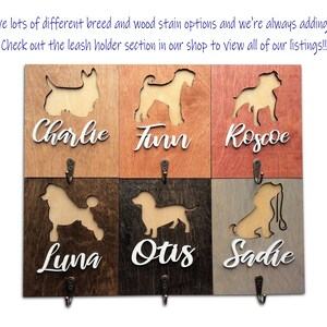 May include: Wooden dog leash holder with six hooks. Each hook has a cutout of a different dog breed and a personalized name below: Charlie, Finn, Roscoe, Luna, Otis, and Sadie.