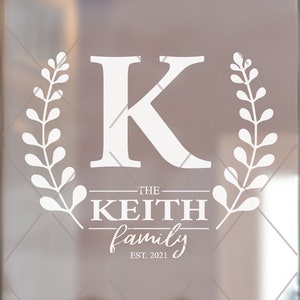 May include: White vinyl decal with a large letter K surrounded by leafy branches. The text "THE KEITH family EST. 2021" is below the letter.