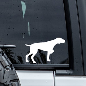 May include: White silhouette of a German Shorthaired Pointer dog on a black car window.