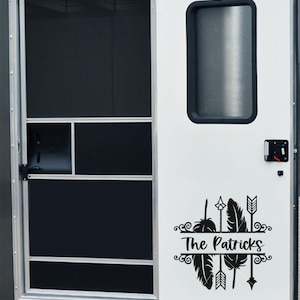 May include: A white door with a black and white vinyl decal featuring the text "The Patricks" with arrows and feathers.
