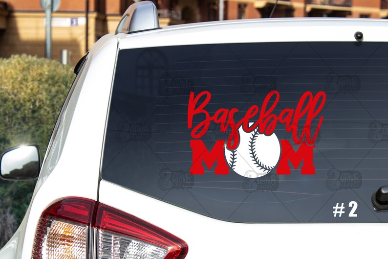 May include: Red vinyl decal with the words "Baseball Mom" and a white baseball. The decal is on the back window of a white car. #2