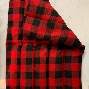 May include: Red and black buffalo check fabric heating pad with multiple compartments.
