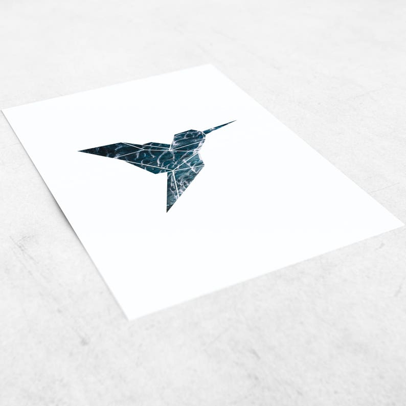 May include: A geometric hummingbird silhouette with a blue and green watercolour pattern.