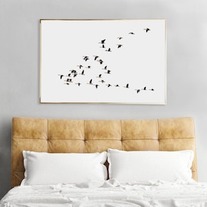 K&ouml;nnte beinhalten: Ein gerahmter Druck einer Vogelschar, die in Formation vor einem wei&szlig;en Hintergrund fliegt. Die V&ouml;gel sind alle in die gleiche Richtung ausgerichtet und fliegen in V-Form.