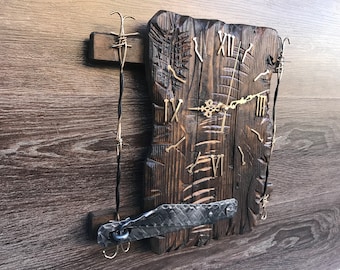May include: A rustic wooden clock with Roman numerals and a metal frame. The clock is attached to a wall with barbed wire.