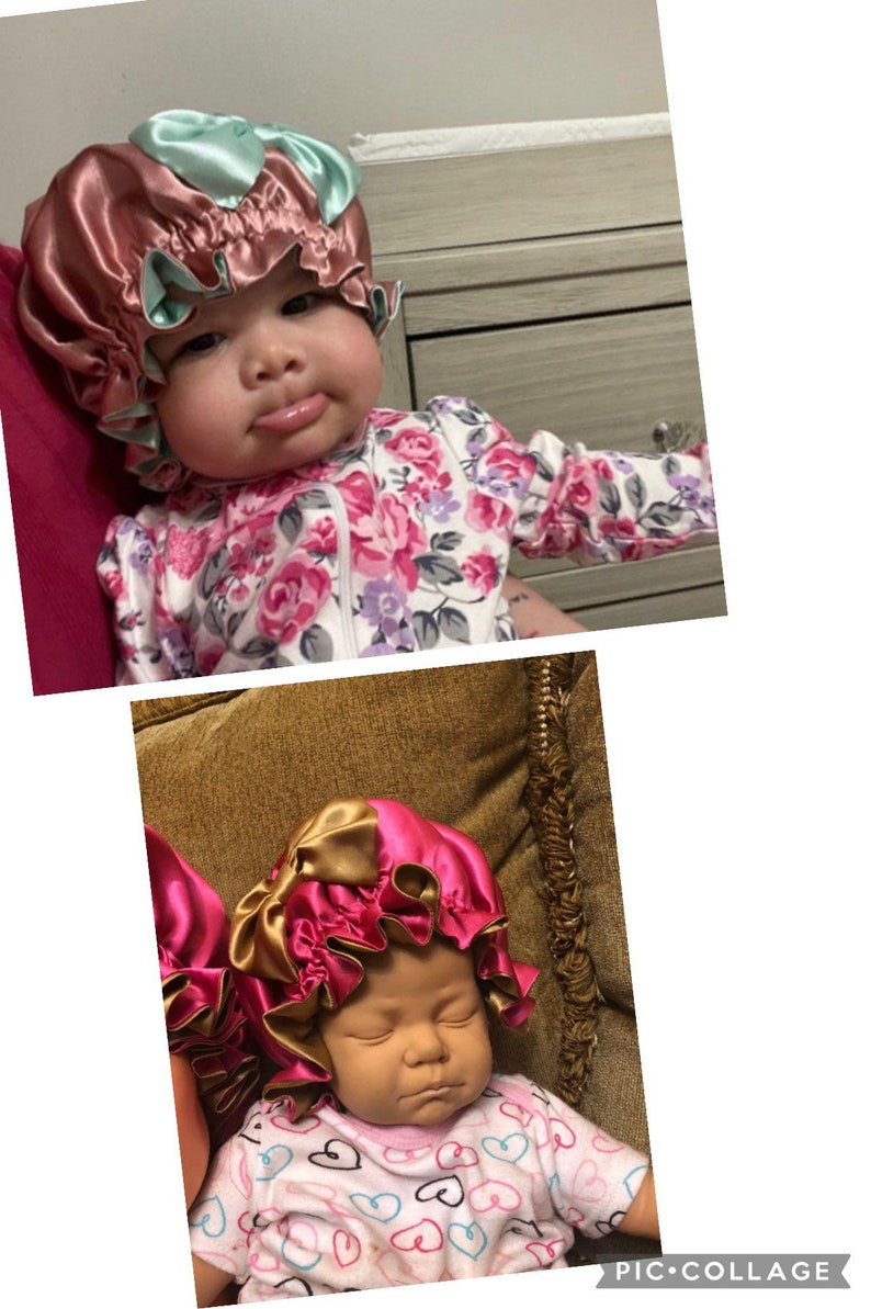 May include: Satin baby bonnet in shades of pink and gold, with a contrasting mint green trim. The bonnet is ruffled and appears to be handmade. The baby is wearing a floral onesie.