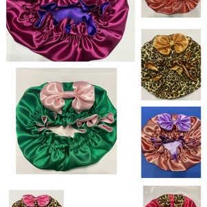 May include: A collage of satin bonnets in various colors, including fuchsia, teal, green, and leopard print. Each bonnet features a contrasting bow and a gathered edge. The bonnets are designed for hair protection and styling.