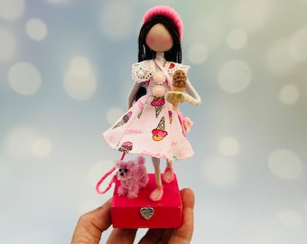 Girl in pink walking her dog doll. Handmade art doll.