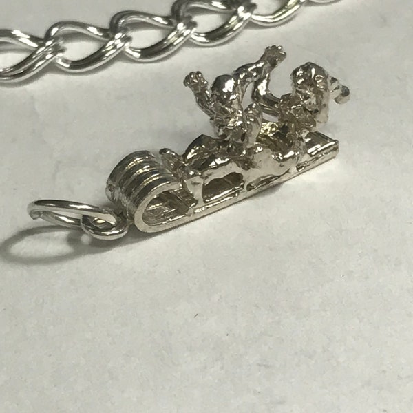 Toboggan charm with riders