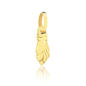 May include: A gold charm in the shape of a closed fist. The charm is designed to be added to a necklace or bracelet.