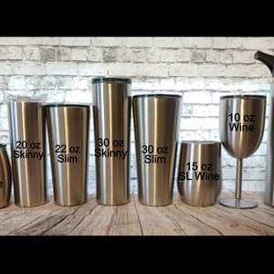May include: A collection of stainless steel drinkware, including a 14 oz coffee mug, various tumblers labeled 20 oz Skinny, 22 oz Slim, and 30 oz Skinny and Slim, a 15 oz SL Wine tumbler, a 10 oz wine glass, and a 25 oz Hydro bottle.