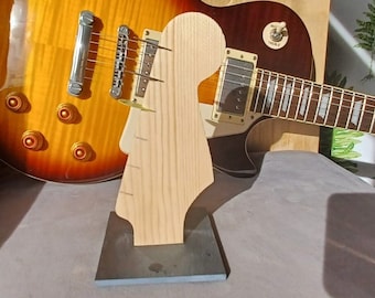 Guitar pick holder in the style of an electric guitar headstock.
