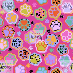 May include: A vibrant pink pattern featuring colorful paw prints in various sizes and designs. The paw prints have multiple colors, including orange, green, purple, and black, with some having checkered, leopard, and striped patterns. The words "TRENDY WOOS" are in the corners.