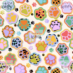 May include: A repeating pattern of colorful paw prints in various sizes and designs. The paw prints feature a variety of patterns, including leopard print, checkered, and solid colors. The background is a light beige color, and the text "Trendy Woos" is visible.