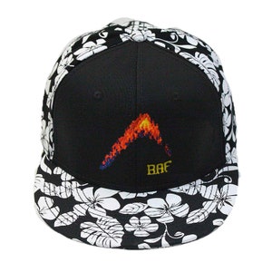 May include: Black and white floral patterned baseball cap with a black crown and a red and yellow flame design with the text "BAF" embroidered on the front.