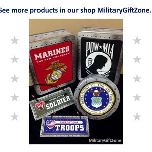 May include: Four metal signs with military themes. The signs feature the words "Marines", "POW MIA", "United States Soldier", and "Support Our Troops".