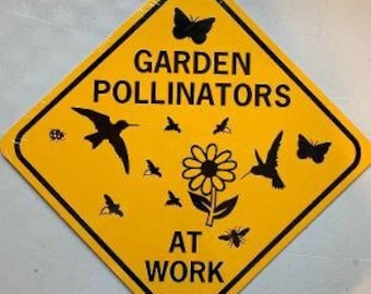 May include: Yellow diamond-shaped sign with black text that reads "Garden Pollinators at Work". The sign features a black silhouette of a hummingbird, butterfly, and flower.