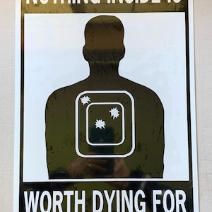 May include: Black and white sign with the text "NOTHING INSIDE IS WORTH DYING FOR". The sign features a silhouette of a person with a target on their chest.