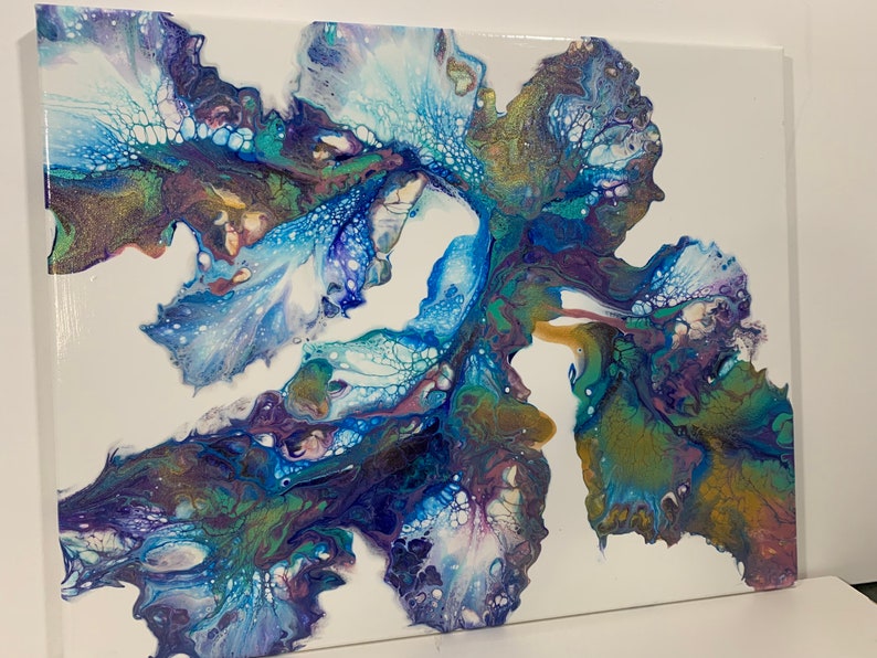 May include: Abstract painting on canvas with blue, green, purple, and white colors. The paint has a fluid, flowing effect, creating a unique and dynamic design.