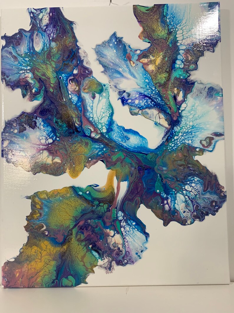May include: Abstract painting with swirling blue, green, gold, and purple paint on a white canvas. The paint creates a flowing, organic design.