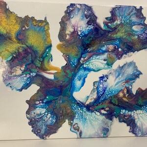 May include: Abstract painting on canvas with blue, white, purple, and gold paint. The paint is swirled and layered to create a unique design.