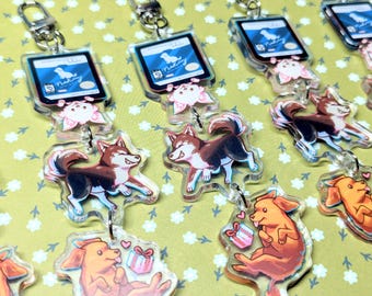 May include: Five colorful keychains featuring cartoon dogs and a small gift box. Each keychain has a blue and white card with the text "Nutzy" on it.