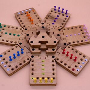May include: A wooden game board with six hexagonal pieces, each with a different color of pegs. The pegs are arranged in a line on each board, with the colors being blue, green, orange, red, purple, and yellow.