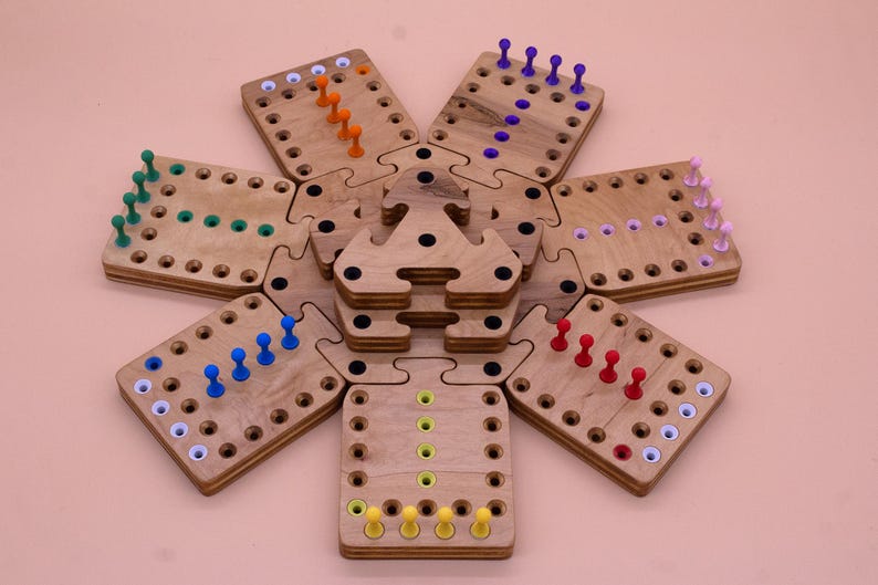 May include: A wooden game board with six hexagonal pieces, each with a different color of pegs. The pegs are arranged in a line on each board, with the colors being blue, green, orange, red, purple, and yellow.