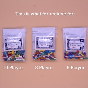 May include: Three bags of colorful wooden game pieces, labeled "10 Player", "8 Player", and "6 Player". Each bag includes a card that says "WooglerDesigns.com Training Cards".