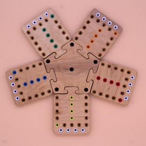 May include: A wooden game board with five sections, each with a different colored pattern of dots. The sections are arranged in a star shape and fit together like a puzzle.