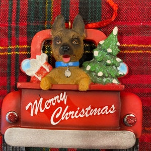 German Shepard Sitting in a Red Truck