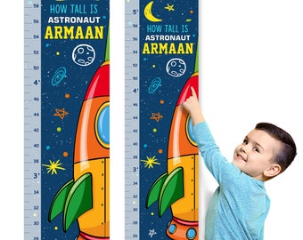 May include: A blue and orange rocket ship themed growth chart with a white moon and stars. The chart is labeled "How Tall Is Astronaut Armaan" and has measurements in inches from 26 to 58 inches.