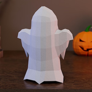 May include: A low-poly ghost figurine crafted with a matte white finish, featuring a geometric, faceted surface design. The ghost has a rounded head, two outstretched arms, and a pointed base, creating a structured, angular appearance.