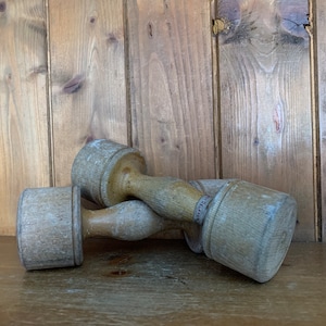 A near pair of Vintage wooden exercise dumbbells/clubs