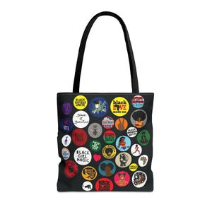May include: Black tote bag with black handles. The bag is covered in colorful circular graphics with phrases like "Black Girl Magic," "Black Love," and "Black Women Matter." The bag is made of a durable material.