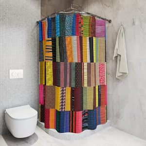 May include: A colorful patchwork shower curtain with a variety of patterned fabric strips in shades of blue, orange, green, and pink. The curtain hangs from a curved metal rod in a bathroom setting.