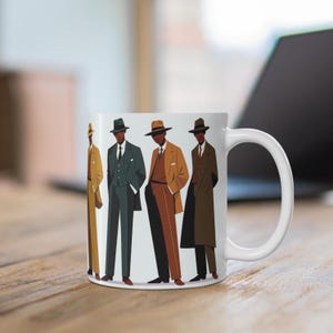 May include: White ceramic mug with a design of four men in suits and hats. The men are illustrated in shades of brown, green, and tan. The mug has a curved handle and is set against a blurred background.