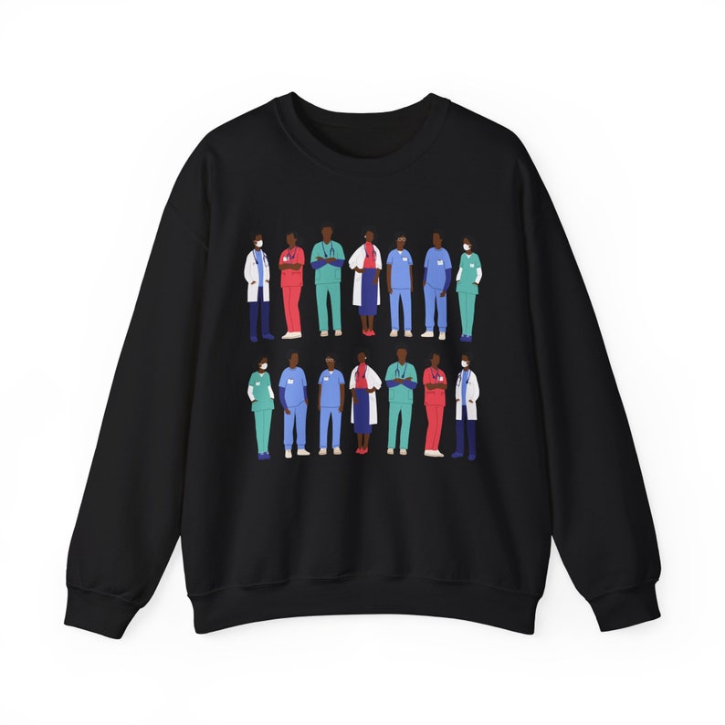 May include: Black sweatshirt with a graphic print of a group of diverse healthcare workers wearing scrubs and masks. The workers are standing in a line, with their arms crossed.