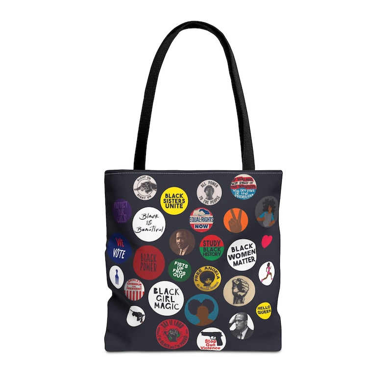 May include: Black tote bag with black handles, covered in colorful circular graphics. The graphics include text such as "Black is Beautiful", "Black Sisters Unite", "Black Women Matter", and "Black Girl Magic".