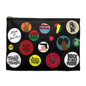 May include: Black canvas zippered pouch with various colorful round buttons featuring phrases like "Black is Beautiful", "Black Power", "Black Minds Matter", "Black Sisters Unite", "Study Black History", "Stop Gun Violence", "Fists Up Fros Out", and "Say It Loud I'm Black and I'm Proud".